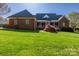 Beautiful backyard with well-maintained lawn, landscaping, and brick home at 105 Snead Ct, Salisbury, NC 28144