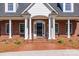 Elegant home entrance showcasing brick facade, white columns, and a stylish black front door at 105 Snead Ct, Salisbury, NC 28144