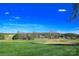 Scenic view of a lush green golf course with fairways and surrounding trees under a bright blue sky at 105 Snead Ct, Salisbury, NC 28144