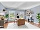 Well-lit home office with shelving and large windows overlooking a landscaped yard at 105 Snead Ct, Salisbury, NC 28144