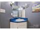 Bathroom vanity with blue countertop, large mirror, sconces, and gray walls at 1050 Merrywood Dr, Newton, NC 28658