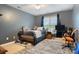 Bedroom with gray walls features a bed, TV, window with blinds, and gray carpet at 1050 Merrywood Dr, Newton, NC 28658