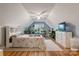 Inviting bedroom with unique vaulted ceilings, plants, dresser, and wood floors at 1050 Merrywood Dr, Newton, NC 28658