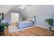 Bright, plant-filled bedroom with light walls, vaulted ceilings, and hardwood floors at 1050 Merrywood Dr, Newton, NC 28658