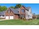 Charming brick and siding home with a well-manicured lawn and attached two-car garage at 1050 Merrywood Dr, Newton, NC 28658