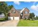 Inviting two-story brick home with a two-car garage, manicured lawn, and classic black shutters at 1050 Merrywood Dr, Newton, NC 28658