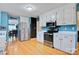 Bright kitchen with white cabinets, stainless steel appliances, and an adjacent dining area at 1050 Merrywood Dr, Newton, NC 28658