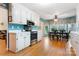 Bright kitchen with white cabinets, stainless steel appliances and a view to the breakfast area at 1050 Merrywood Dr, Newton, NC 28658