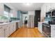Updated kitchen featuring stainless appliances, white cabinets, and wood floors at 1050 Merrywood Dr, Newton, NC 28658