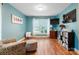 Comfortable living room features bright window, wall-mounted TV, hardwood floors, and stylish decor at 1050 Merrywood Dr, Newton, NC 28658
