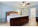 Spacious main bedroom boasts hardwood floors, a large bed, ceiling fan, and access to the bathroom at 1050 Merrywood Dr, Newton, NC 28658
