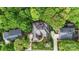 An aerial view showcases the home's roof, landscaping, driveway and wooded surroundings at 11424 Stonebriar Dr, Charlotte, NC 28277