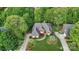 Aerial view featuring home with brick facade, mature trees, and well-manicured landscaping at 11424 Stonebriar Dr, Charlotte, NC 28277