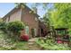 Backyard featuring a brick home, decks, lush landscaping, and a beautiful wooded setting at 11424 Stonebriar Dr, Charlotte, NC 28277