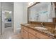 Bathroom featuring double sinks with granite countertop, a large mirror, and a walk-in shower with a curtain at 11424 Stonebriar Dr, Charlotte, NC 28277