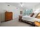 This bright bedroom features a dresser, closet, and a large window with plantation shutters at 11424 Stonebriar Dr, Charlotte, NC 28277