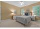 Bedroom with neutral walls, carpet flooring, a ceiling fan, and two shuttered windows allowing ample natural light at 11424 Stonebriar Dr, Charlotte, NC 28277