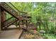 Multi-level deck and pergola offer scenic wooded views, creating an outdoor oasis at 11424 Stonebriar Dr, Charlotte, NC 28277