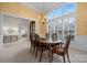 Dining room with high ceilings, large window with shutters, chandelier, and view to the living room at 11424 Stonebriar Dr, Charlotte, NC 28277