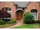 Inviting front entrance with a brick pathway and lush landscaping adds a touch of elegance at 11424 Stonebriar Dr, Charlotte, NC 28277