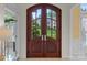 Elegant arched double front doors with glass panels, providing a glimpse of the beautiful outdoors at 11424 Stonebriar Dr, Charlotte, NC 28277