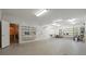 Well-lit garage with pegboard walls, shelving, and an entrance into living space at 11424 Stonebriar Dr, Charlotte, NC 28277