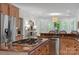Spacious kitchen featuring stainless steel appliances, granite countertops, and light wood cabinets at 11424 Stonebriar Dr, Charlotte, NC 28277