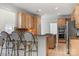 Well-lit kitchen featuring stainless appliances, wooden cabinets, granite countertops, and barstool seating at 11424 Stonebriar Dr, Charlotte, NC 28277