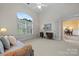 Bright living room with a large window, shutters, adjacent dining room and a comfortable seating area at 11424 Stonebriar Dr, Charlotte, NC 28277