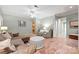 This cozy living room has tile floors, neutral paint, a ceiling fan, and lots of natural light at 11424 Stonebriar Dr, Charlotte, NC 28277