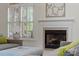 Cozy living room featuring a fireplace, and large windows, offering a comfortable and inviting space at 11424 Stonebriar Dr, Charlotte, NC 28277
