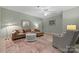 This cozy living room has neutral paint, a ceiling fan, a brown sofa, and a decorative coffee table at 11424 Stonebriar Dr, Charlotte, NC 28277