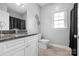 Well-lit bathroom featuring a granite countertop, white cabinets, and a window, creating a bright, clean aesthetic at 121 Capstone Ct, Statesville, NC 28625