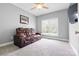 Comfortable bedroom with a plush leather couch and ceiling fan, ideal for relaxation and entertainment at 121 Capstone Ct, Statesville, NC 28625