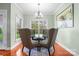 Bright dining area with modern chandelier, rug and furniture, and backyard views at 121 Capstone Ct, Statesville, NC 28625