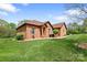 Charming brick home with manicured lawn, complemented by mature trees and inviting front entrance at 121 Capstone Ct, Statesville, NC 28625