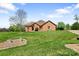 All brick home situated on a green lawn with a beautiful blue sky backdrop, offering curb appeal at 121 Capstone Ct, Statesville, NC 28625