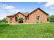 All-brick single-story home featuring a well-manicured lawn, mature landscaping, and classic architectural details at 121 Capstone Ct, Statesville, NC 28625