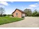 Brick home featuring an attached garage with a white door, a driveway, and landscaped front yard at 121 Capstone Ct, Statesville, NC 28625