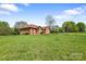 Single-story all brick home with green grass lawn in a scenic setting offering curb appeal at 121 Capstone Ct, Statesville, NC 28625