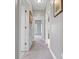 Hallway showcasing neutral walls, carpet, and white doors, creating a clean and bright passage to other areas of the home at 121 Capstone Ct, Statesville, NC 28625