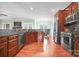 Spacious open kitchen featuring cherry cabinets, stainless appliances, and connecting dining area at 121 Capstone Ct, Statesville, NC 28625