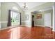 Bright living room with large window, hardwood floors, and a chandelier creating an inviting atmosphere at 121 Capstone Ct, Statesville, NC 28625