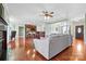 Living room seamlessly connected to a kitchen featuring hardwood floors, a large sectional sofa, and modern lighting at 121 Capstone Ct, Statesville, NC 28625