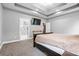 Comfortable main bedroom with tray ceilings, TV, and access to ensuite bath at 121 Capstone Ct, Statesville, NC 28625