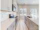Modern kitchen featuring stainless steel appliances, white cabinetry, quartz countertops, and wood grain vinyl flooring at 1216 Morehead Dr, Salisbury, NC 28144