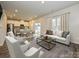 Bright, open-plan living room with hardwood floors, dining area and modern sofa and chairs at 1259 Morehead Dr, Salisbury, NC 28144
