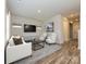 Modern living room with hardwood floors, a TV, light colored sofa and chairs at 1259 Morehead Dr, Salisbury, NC 28144