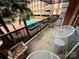 Balcony featuring patio furniture overlooking the community courtyard and pool area at 1300 Queens Rd # 210, Charlotte, NC 28207