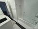 Well-lit bathroom with black and white tile features a shower and quartz countertop vanity at 1300 Queens Rd # 210, Charlotte, NC 28207